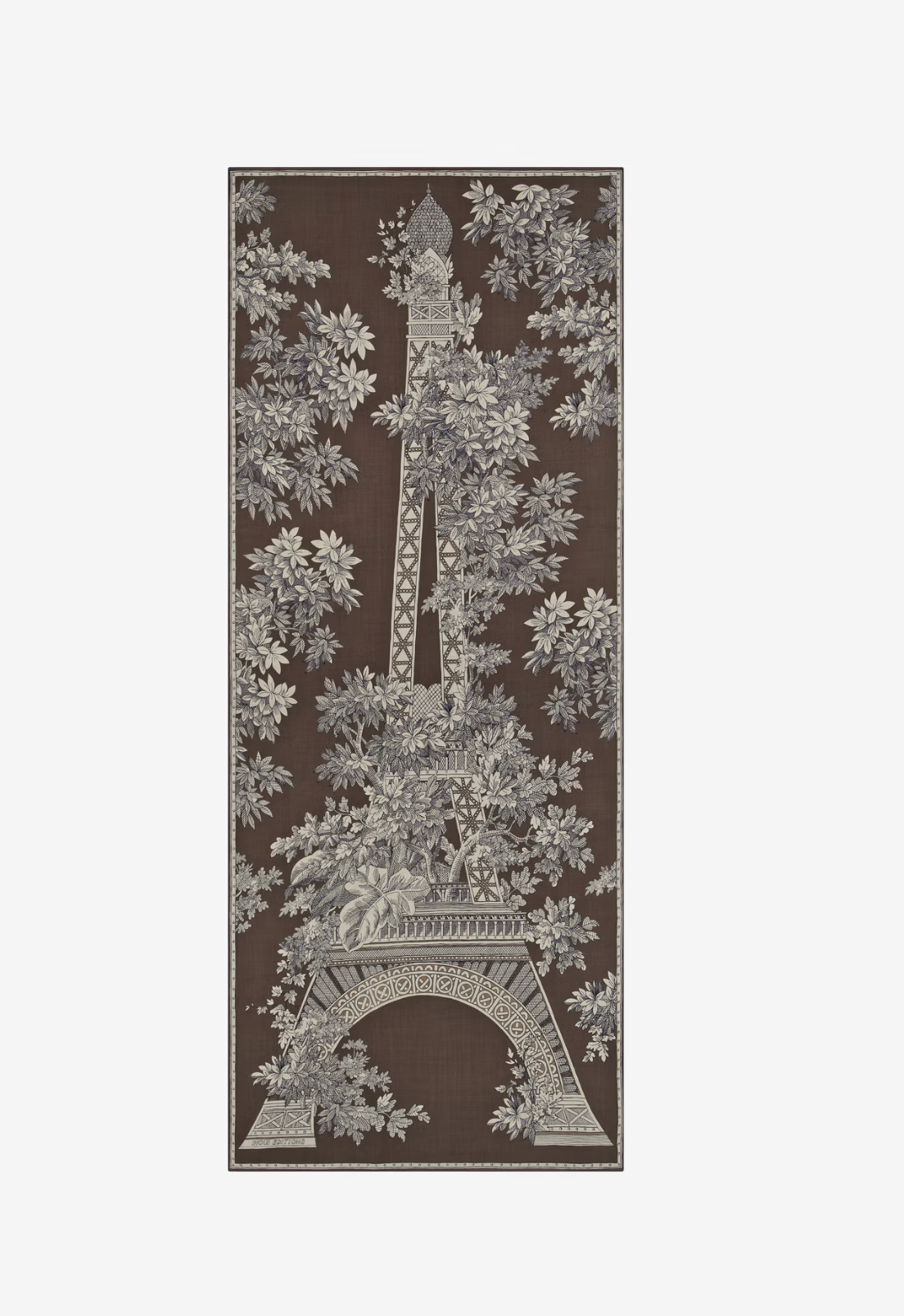 A rectangular area rug featuring a detailed botanical print of the Eiffel Tower surrounded by dense foliage, in dark brown and light gray tones.
