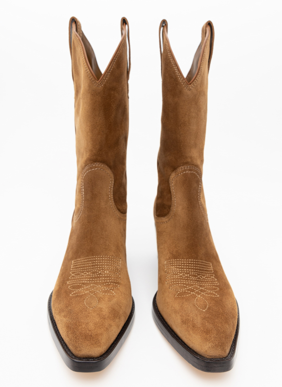A pair of tan suede cowboy boots with pointed toes and decorative stitching on the vamp, shown from a front-facing perspective on a white background.